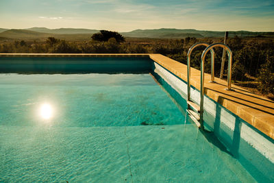 Empty swimming pool with a view towards the mountains.