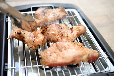 High angle view of meat on barbecue grill