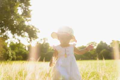 Asian baby girl walking in the meadow with copy space happy family day concept. silhouette.