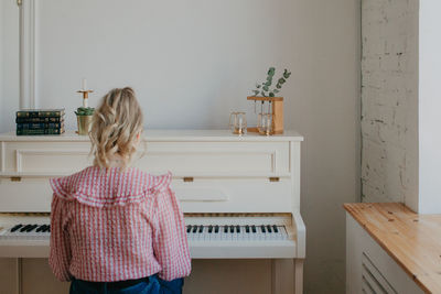 Young beautiful woman playing the piano. high quality photo