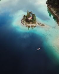 High angle view of rock by sea against sky