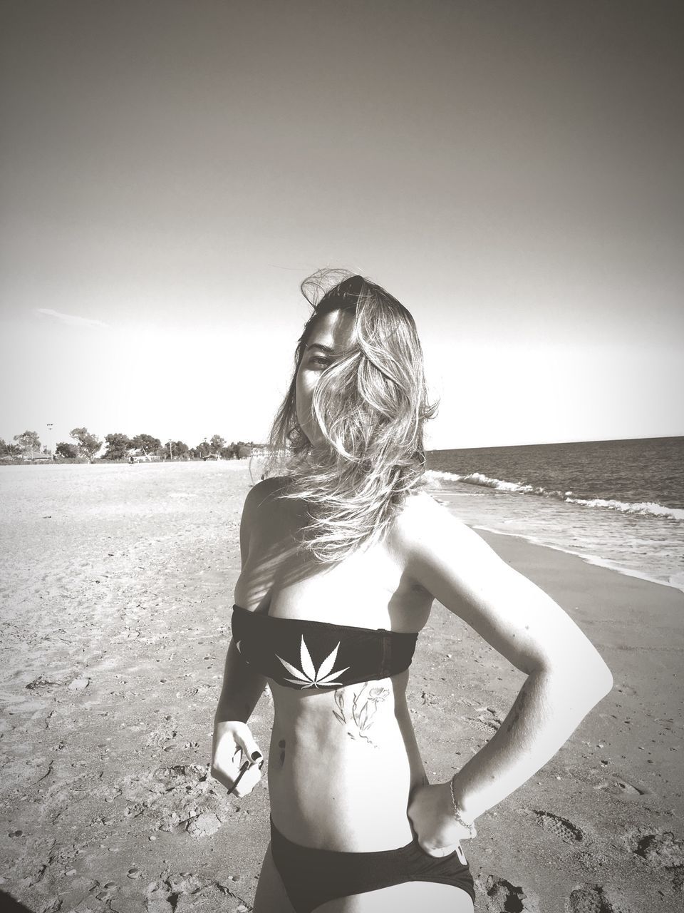 real people, lifestyles, one person, beach, sunlight, sky, day, young adult, young women, sea, outdoors, sand, leisure activity, vacations, clear sky, nature, standing, tranquil scene, horizon over water, women, water, sun, one young woman only, adult, people