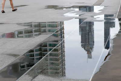 Reflection of building in puddle