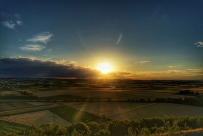 Scenic view of field against sky during sunset