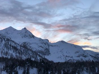 Scenic view of snowcapped mountains against sky during sunset