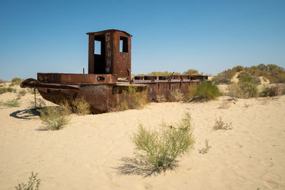 Old ruin on beach against clear sky