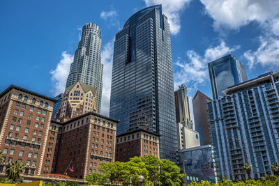 Low angle view of buildings against cloudy sky