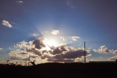 Silhouette man against sky during sunset