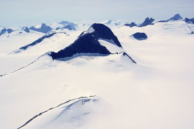 Scenic view of snow covered mountains against sky