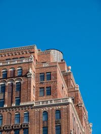 Low angle view of historic building against clear blue sky