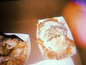 Close-up of hand holding ice cream on table