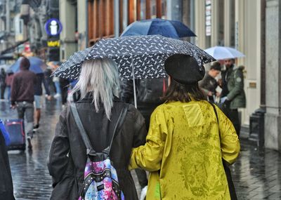 Rear view of people on wet street