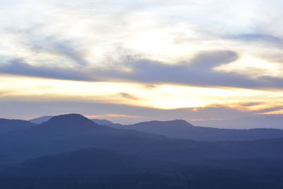 Scenic view of silhouette mountains against sky during sunset