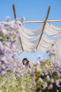 Asian woman relax in flower garden on springtime vacation
