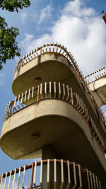 Low angle view of building against cloudy sky