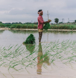 Full length of woman standing in water