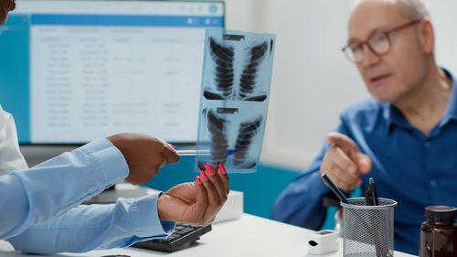 Midsection of scientist working in laboratory