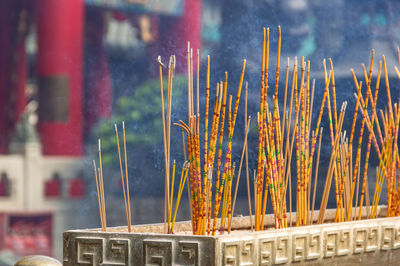 Burning incense sticks on sand box at the temple