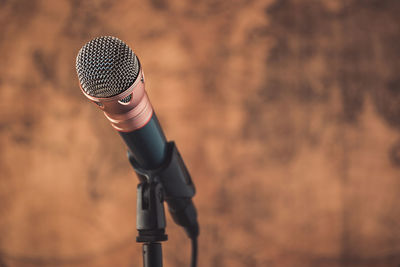 Close-up of microphone against wall