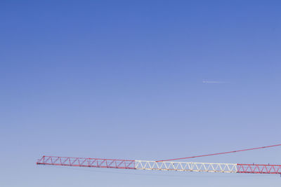 Low angle view of text on building against clear blue sky