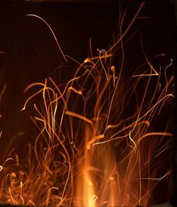 Close-up of illuminated lighting equipment against black background