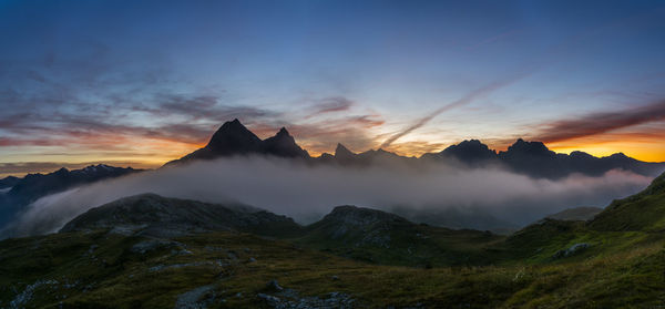 Scenic view of mountains against cloudy sky