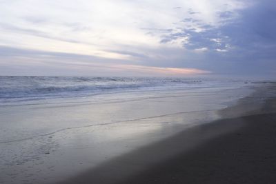 Scenic view of beach against sky during sunset