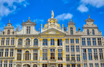 Low angle view of building against cloudy sky