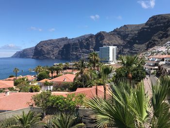 Scenic view of sea and buildings against sky