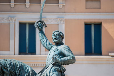 Low angle view of statue against building