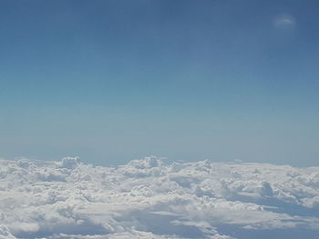 Scenic view of snowcapped mountains against blue sky