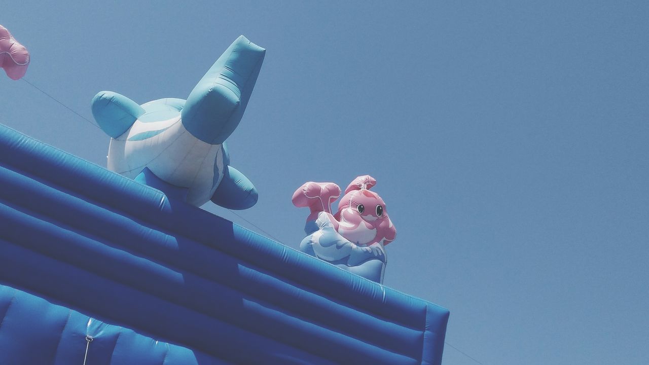 blue, low angle view, sky, no people, clear sky, representation, day, copy space, nature, creativity, art and craft, pink color, plastic, human representation, close-up, craft, outdoors, arts culture and entertainment, inflatable