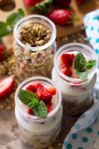 Homemade healthy breakfast with homemade baked granola, fresh strawberry and yogurt. 