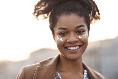 Close-up of young woman against white background