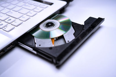 High angle view of compact disc in laptop cd player