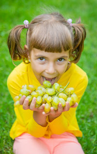 Portrait of girl holding fruits