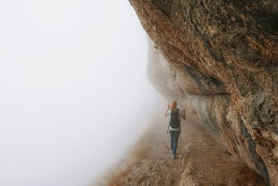 Full length of woman standing on bench