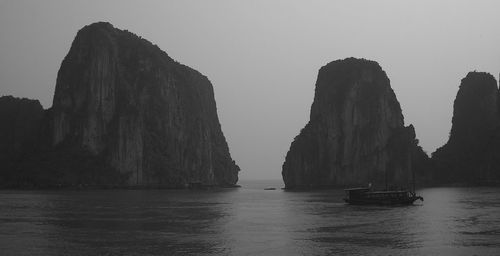 Panoramic view of rocks in sea against sky