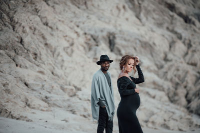 Side view of couple standing outdoors