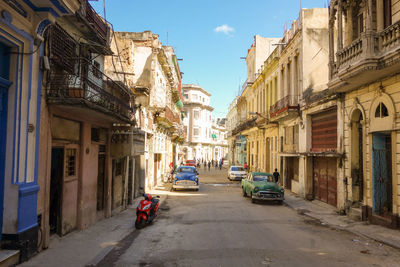 Cars on street amidst buildings in city