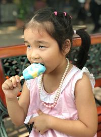 Girl eating ice cream in city