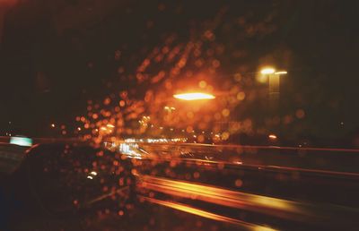 Defocused image of illuminated city at night