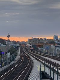 High angle view of train in city against sky during sunset