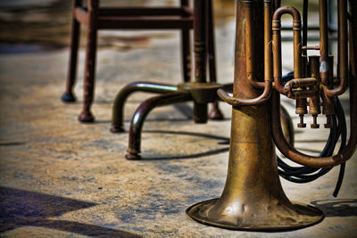 Close-up of trumpet on walkway during sunny day