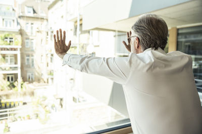 Rear view of a man walking in office