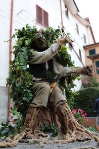 Rear view of man sculpture by building