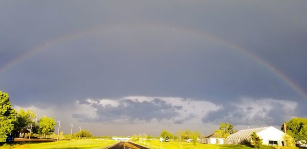 Rainbow over building against sky