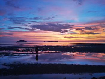 Scenic view of lake against sky during sunset