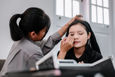 Young woman using laptop at home