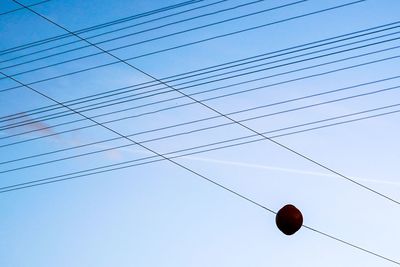 Low angle view of power lines against clear sky